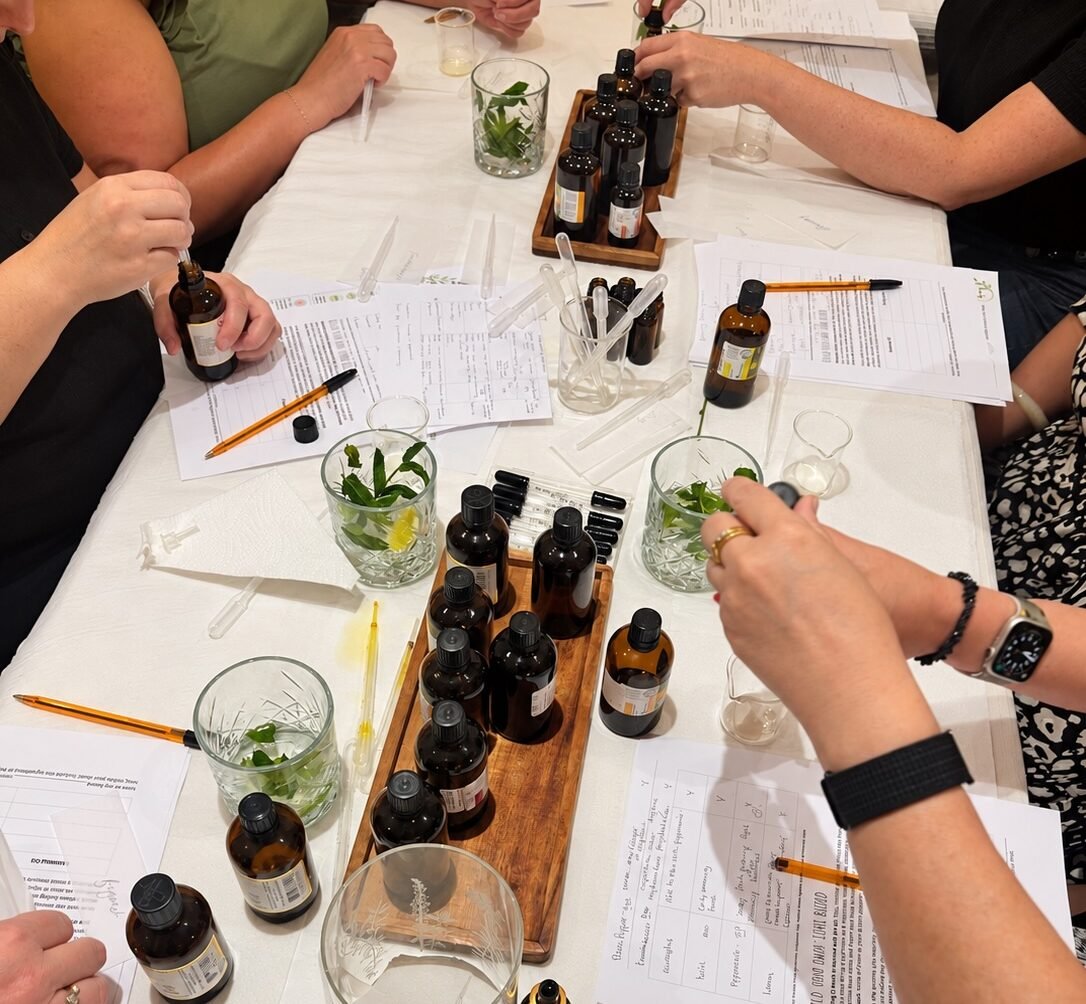 Guests creating personalised essential oil blends at a Blend & Unwind aromatherapy workshop